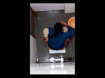 Indian woman with horns changing in the bathroom